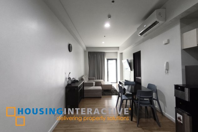 fully-furnished 1 bedroom condo unit with a huge balcony/terrace at solstice towers at circuit makati for sale