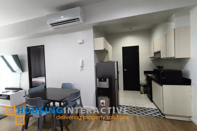 fully-furnished 1 bedroom condo unit with a huge balcony/terrace at solstice towers at circuit makati for sale