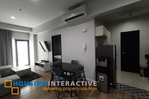 fully-furnished 1 bedroom condo unit with a huge balcony/terrace at solstice towers at circuit makati for sale