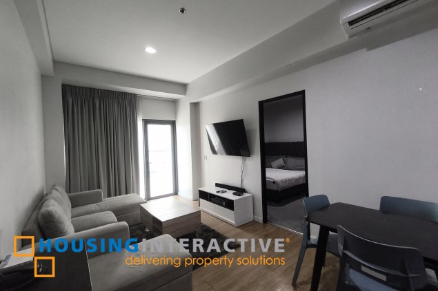 fully-furnished 1 bedroom condo unit with a huge balcony/terrace at solstice towers at circuit makati for sale